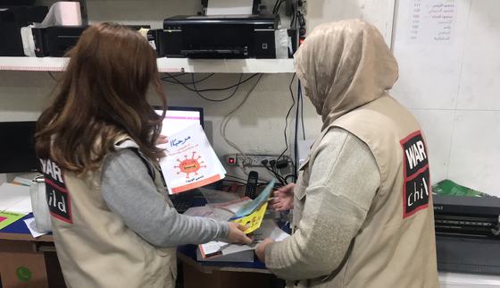 Checking samples psychosocial kits in Gaza_War Child_200414