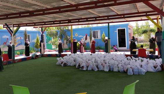 Women standing in line to receive a hygiene and education kit part of the corona response in Jordan_War Child_200510.jpg
